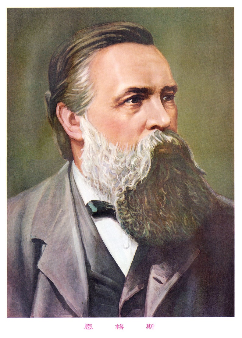 May include: A portrait of a man with a long, gray beard and mustache. He is wearing a gray suit jacket with a dark tie. The background is a muted green.