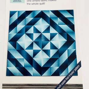 May include: A quilt pattern instruction sheet titled Ombré Star by Hunter's Design Studio. The cover features a blue and white geometric star design made from ombré fabric, with the text one ombré fabric makes the whole quilt and another so much easier than it looks pattern.