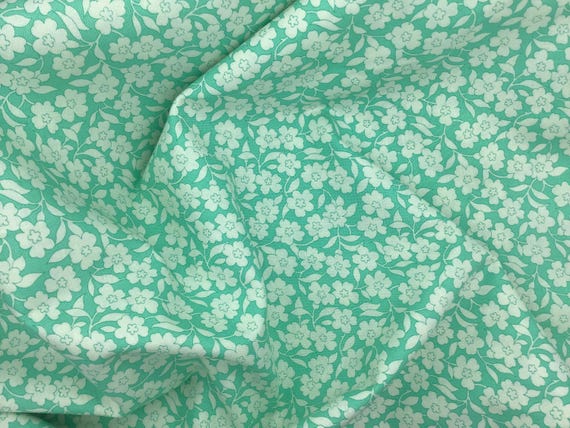 Depression 20s 30s feedsack print 100% cotton. Moda Fabrics flower power teal background with white floral print. Sold by the yard.