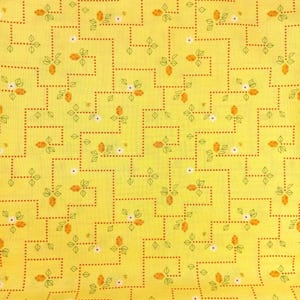 May include: Yellow fabric with a repeating pattern of orange fruit, white flowers, and green leaves. The design is arranged in a geometric zigzag pattern with dotted lines. The fabric has a vintage, retro aesthetic.