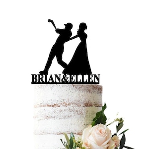 Wedding cake topper Bride dragging groom that plays baseball to the wedding