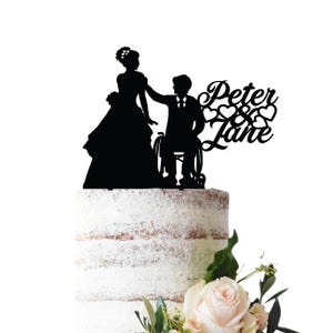Wedding cake topper with groom in wheelchair