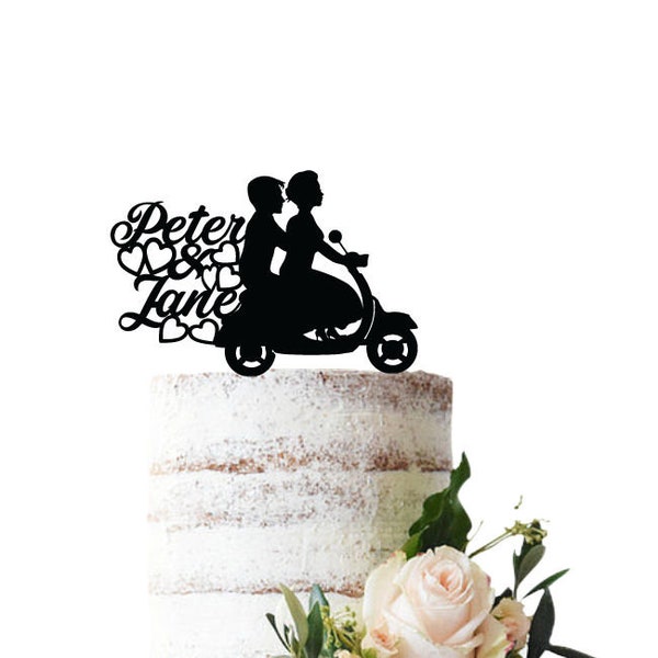 Wedding cake topper with bride and groom on a scooter, bride riding