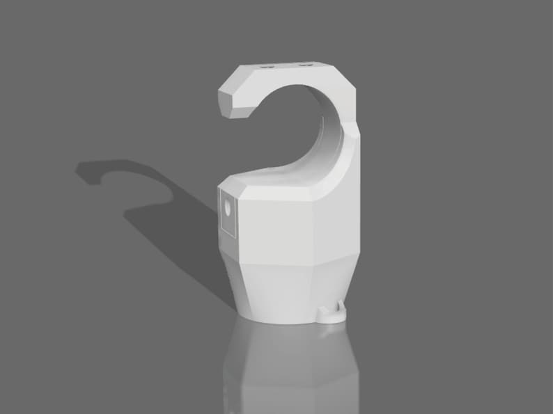 May include: White plastic pipe clamp with a rounded, open top and a flat bottom. The clamp has a textured surface and a small hole on the side.