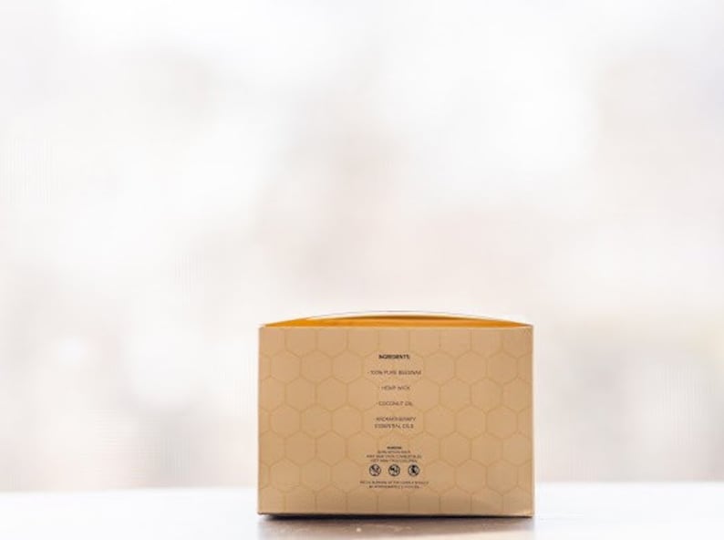 May include: A beige box with a honeycomb pattern and the text "Ingredients: 100% Pure Beeswax, Honey Wax, Coconut Oil, Avocado Oil, Essential Oil" printed on the side.