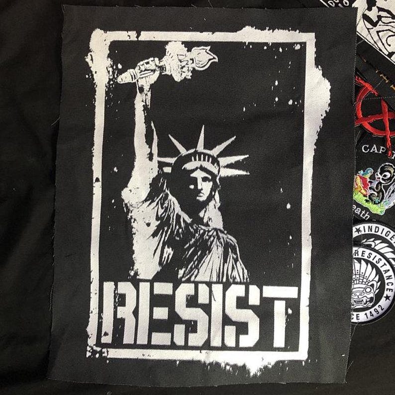 Political punk patch with hand-drawn Statue of Liberty and resist slogan.