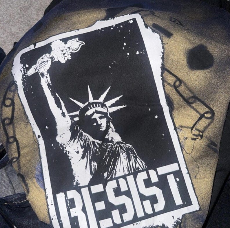 Screen printed cloth patch of Statue of Liberty in punk stencil art style.