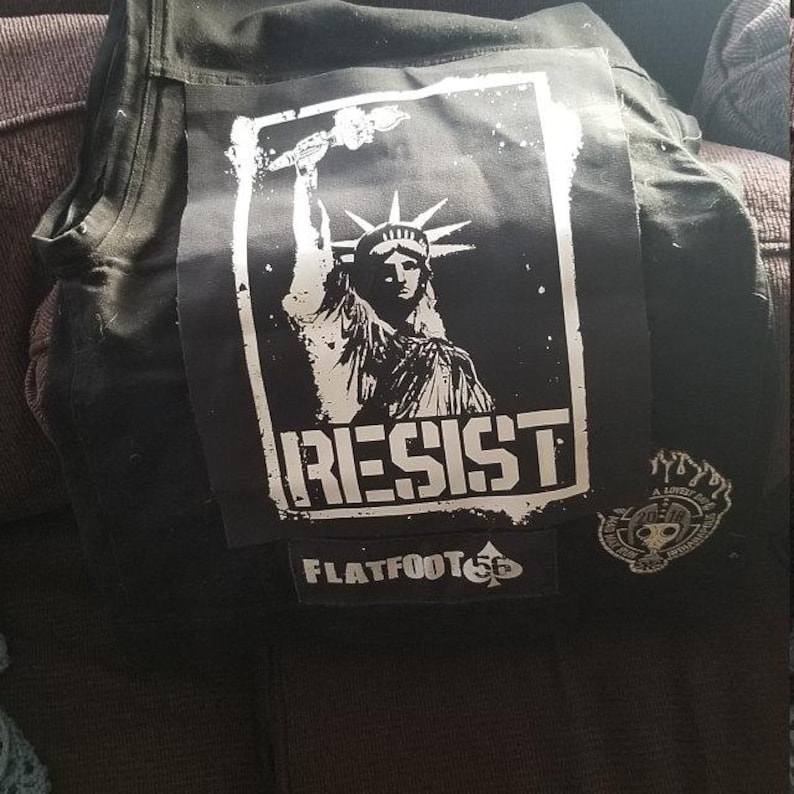 Grunge-style DIY patch with RESIST slogan and Liberty design.