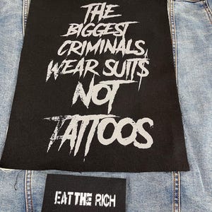 Large punk back patch with bold stencil text 'The Biggest Criminals Wear Suits Not Tattoos', perfect for jackets, vests, and anti-establishment streetwear.