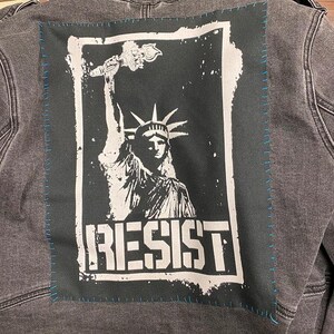 Anti-authority patch with Liberty graphic and resistance message.