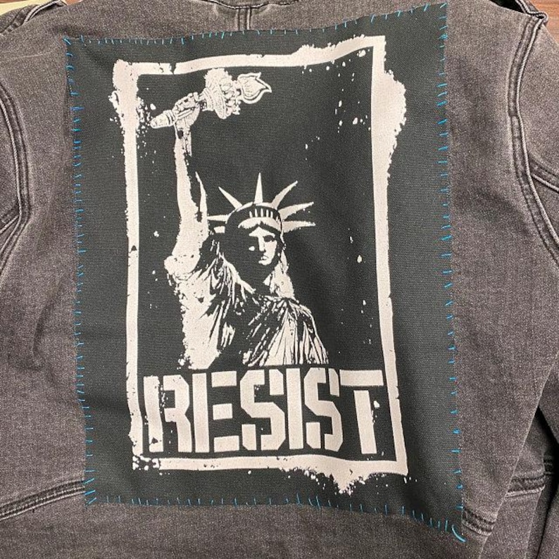 Anti-authority patch with Liberty graphic and resistance message.