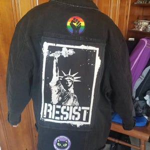 Political punk patch with hand-drawn Statue of Liberty and resist slogan.