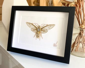 High-fashion insect embroidery in a frame