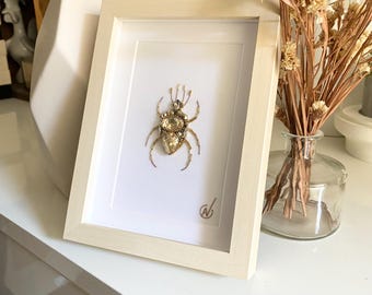 High-fashion insect embroidery in a frame