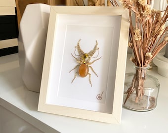 High-fashion insect embroidery in a frame