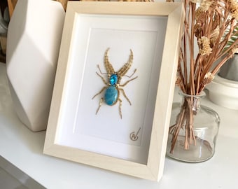 High-fashion insect embroidery in a frame