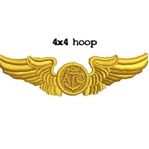 May include: Gold embroidered wings with an anchor and the letters "ATC" in the center. The wings are for a 4x4 hoop.