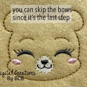 May include: Close-up of a tan felt bear face with embroidered details. The bear has closed eyes with black eyelashes, a white nose, and pink cheeks. The text "you can skip the bows since it's the last step" is at the top. The text "Digital Creations By BCB" is at the bottom.