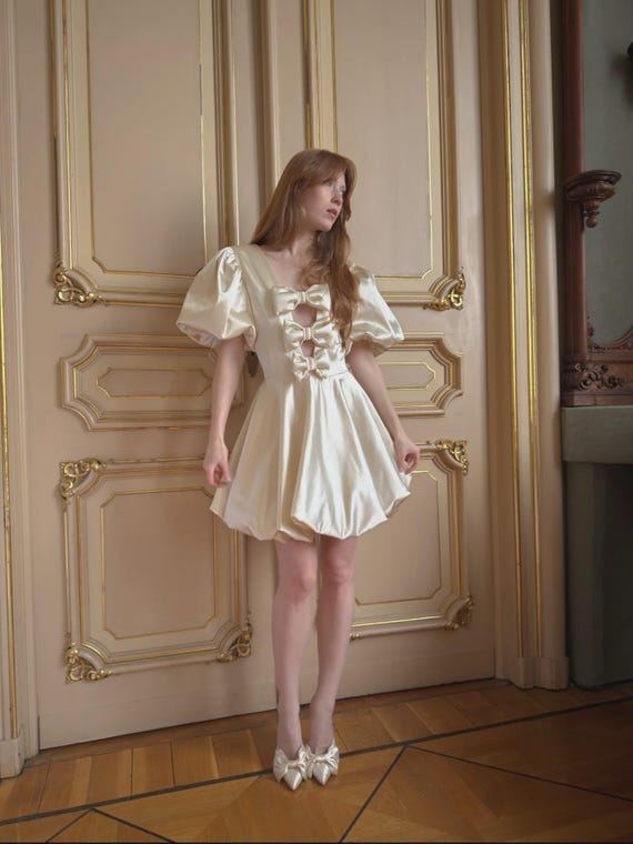 cream bow dress Leire Cream Midi Dress with Asymmetrical Bow Detail