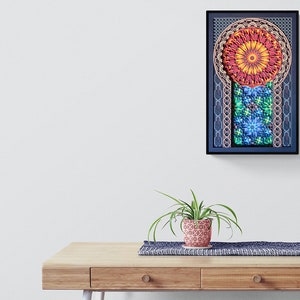 May include: A framed print of a colourful mandala design with geometric patterns in shades of red, orange, yellow, green, blue, and purple. The mandala is surrounded by a black frame.