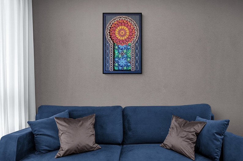 May include: A blue sofa with two brown throw pillows and a framed artwork with a colourful mandala design hanging on the wall behind it.