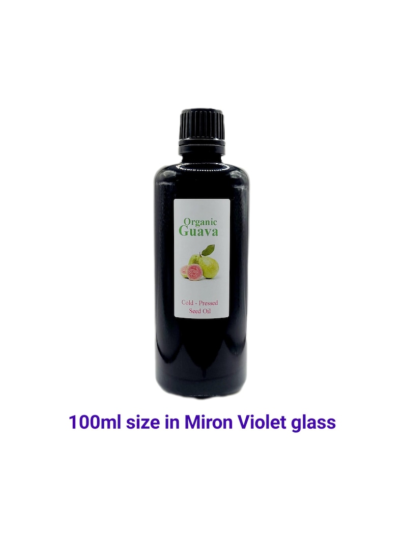 May include: A 100 ml bottle of organic guava seed oil in a dark violet glass bottle. The bottle has a black cap and a label that says "Organic Guava Cold-Pressed Seed Oil".