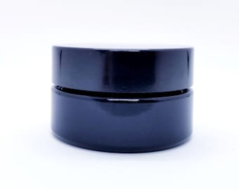 May include: A black glass jar with a black lid. The jar is empty and has a smooth, glossy finish.