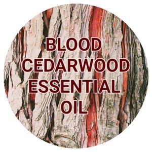 May include: Close-up of a tree bark texture with the text "BLOOD CEDARWOOD ESSENTIAL OIL" in red lettering.