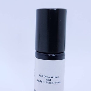 May include: A black roll-on bottle with a white label that reads "Roll Onto Wrists and Apply to Pulse Points".