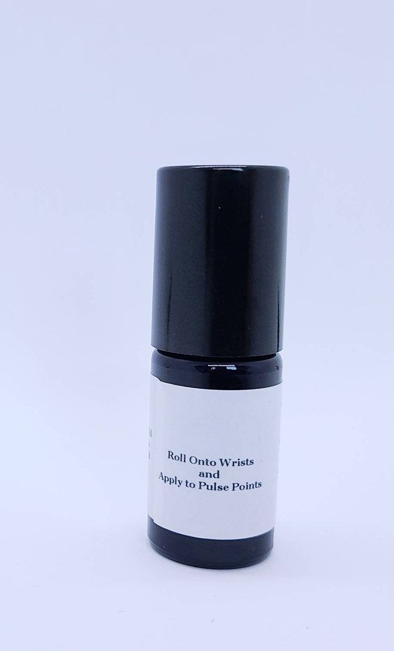 May include: A black roll-on bottle with a white label that reads "Roll Onto Wrists and Apply to Pulse Points".