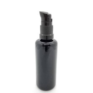 May include: A black glass bottle with a black pump dispenser. The bottle is opaque and has a smooth, shiny finish.