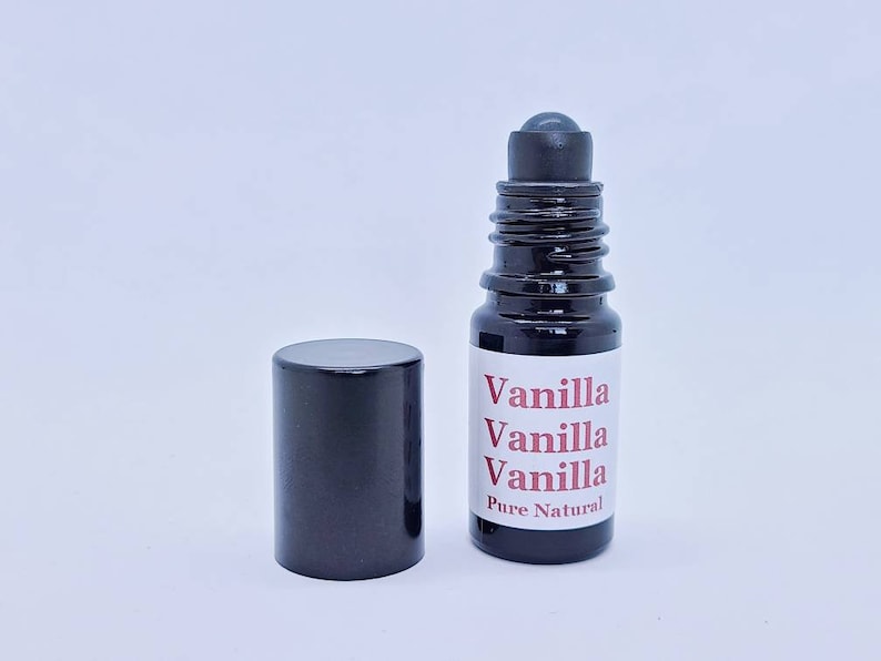 May include: A black roller bottle with a white label that reads "Vanilla Vanilla Vanilla Pure Natural".