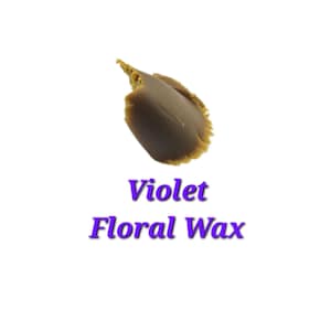 May include: A close-up of a brown wax block with a slightly textured surface. The wax is labeled "Violet Floral Wax".