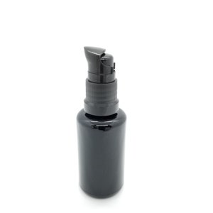 May include: A black glass bottle with a black pump dispenser. The bottle is opaque and has a smooth, shiny finish.