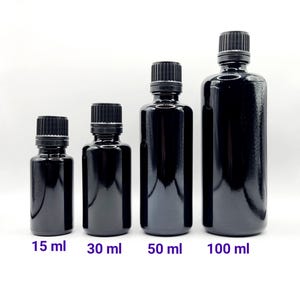 May include: Four black glass bottles with black screw-on caps. The bottles are labeled with their volume in milliliters: 15 ml, 30 ml, 50 ml, and 100 ml.