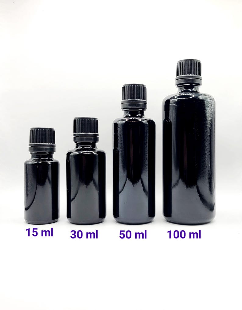 May include: Four black glass bottles with black screw-on caps. The bottles are labeled with their volume in milliliters: 15 ml, 30 ml, 50 ml, and 100 ml.