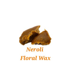 May include: Close-up of a broken piece of brown wax with the text "Neroli Floral Wax" below it.