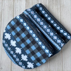 May include: A blue and black patterned fabric with a geometric design. The fabric is folded into a rectangular shape.