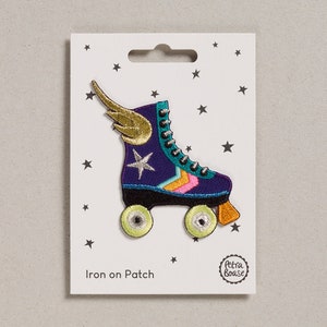 May include: Iron-on patch featuring a colorful roller skate with a gold wing, a white star, and the text "Iron on Patch".