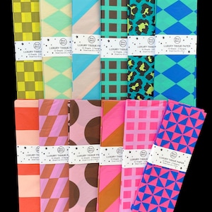 May include: Twelve folded packs of luxury tissue paper arranged in two rows. Each pack features distinct patterns including checkers, diamonds, stripes, and animal prints in vibrant colours like lime, teal, pink, and orange. Each pack has a white paper band labelled Luxury Tissue Paper with 10 sheets and a sheet size of 50 x 70cm.