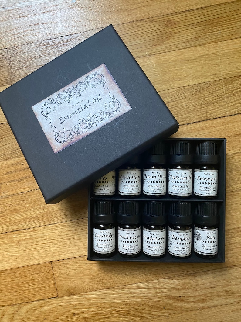 May include: A black box with a label that says "Premium Essential Oil" and contains 10 small glass bottles of essential oils. The bottles are labeled with the names of the oils, including Lavender, Frankincense, Sandalwood, Bergamot, and Rose.