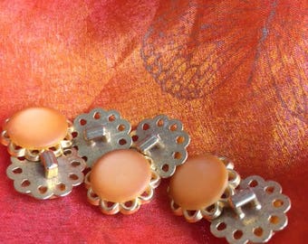 set di 7 bottoni vintage in resina arancione e metallo dorato