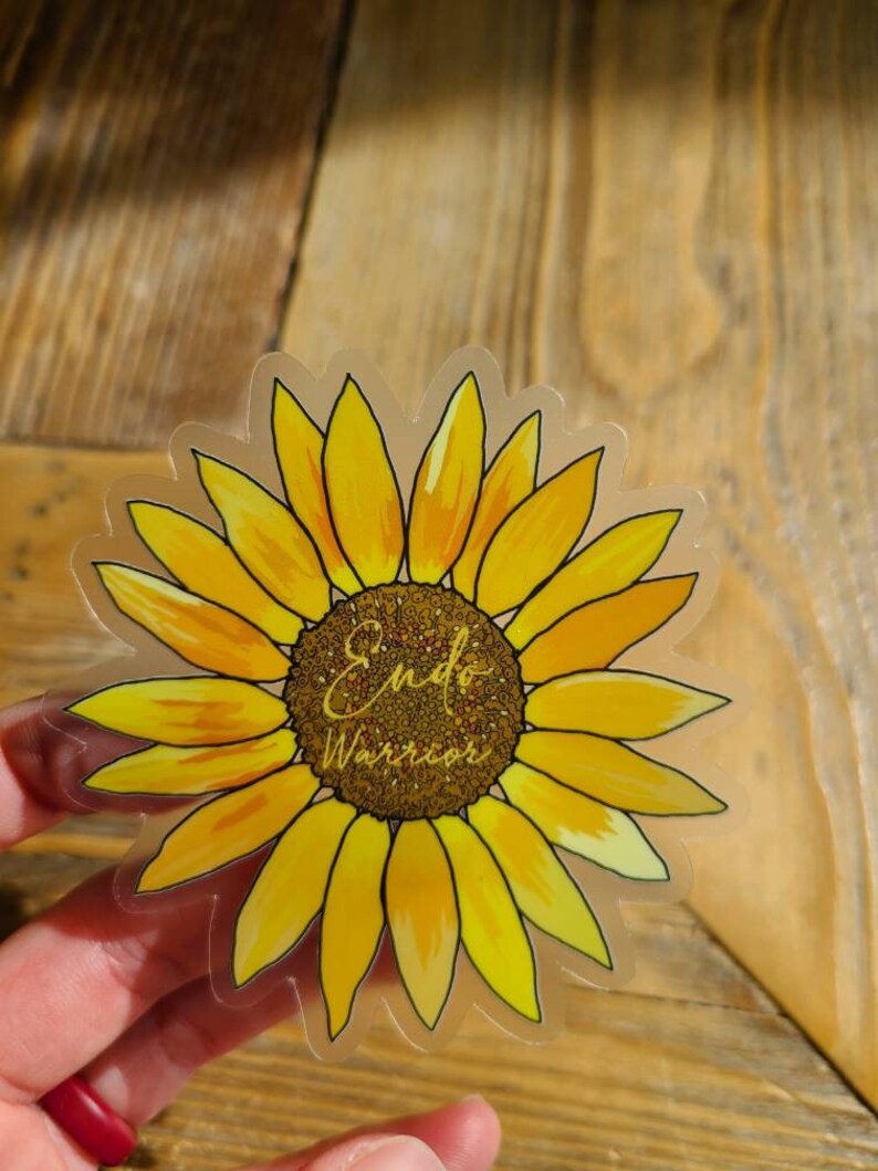 May include: Clear sticker with a yellow sunflower and the text "Endo Warrior" in gold glitter lettering.