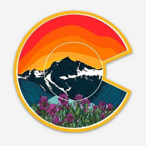 May include: A colorful sticker featuring a stylized outline of the state of Colorado with a mountain range and a sunset in the background. The mountain range is outlined in dark blue and white, with a sunset in shades of orange, red, and yellow. The sticker is surrounded by a yellow border and features a field of purple wildflowers in the foreground.