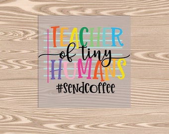 May include: A colorful sign with the text "Teacher of tiny humans #SendCoffee" on a light gray background with blue and white stripes.