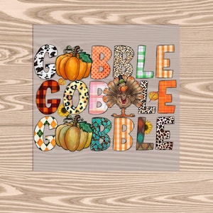 May include: Gobble Gobble Gobble text with a turkey and pumpkins in a patchwork design. The letters are in different colors and patterns.