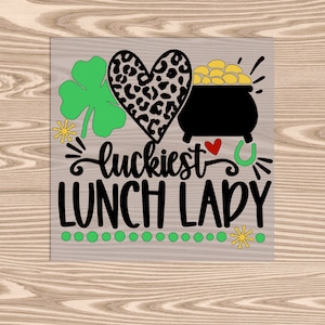 May include: A wooden sign with the text "luckiest lunch lady" in black lettering. The sign is decorated with a green shamrock, a leopard print heart, a pot of gold, a red heart, and a gold horseshoe.