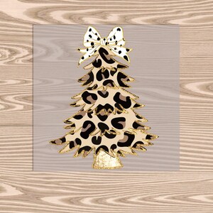 May include: A gold and black Christmas tree with a leopard print design and a white and black bow on top.