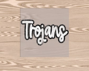 May include: The word "Trojans" in a white, distressed font with a black outline. The text is centered on a light gray square, set against a light wood grain background.