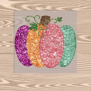 May include: A colorful pumpkin made of sequins in shades of pink, green, orange, and purple. The pumpkin has a stem and leaves.
